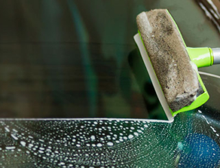 Squeegee cleaning car windshield