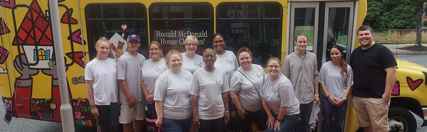 f&p volunteers in front of ronald mcdonald house bus