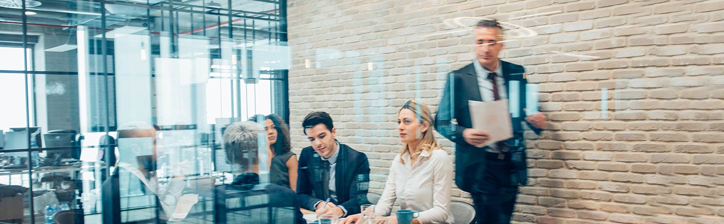 meeting in a conference room with brick wall