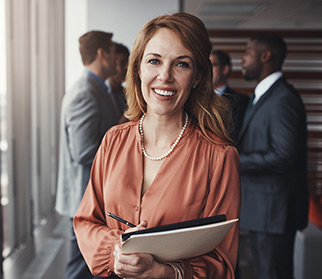 smiling confident businesswoman holding pad